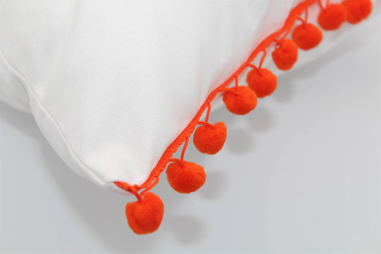 El Mar Pillow Collection: White with Orange Pom Poms