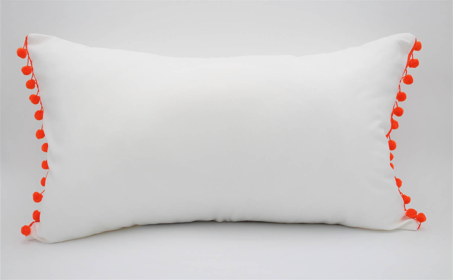 El Mar Pillow Collection: White with Orange Pom Poms