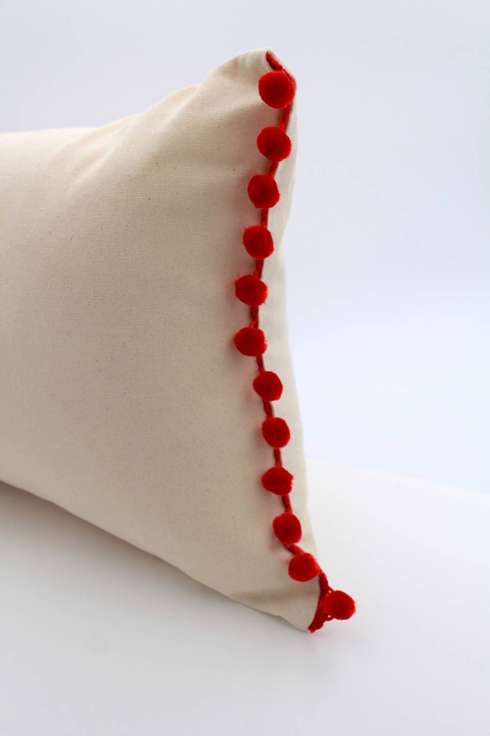 El Mar Pillow Collection: Natural with Red Pom Poms